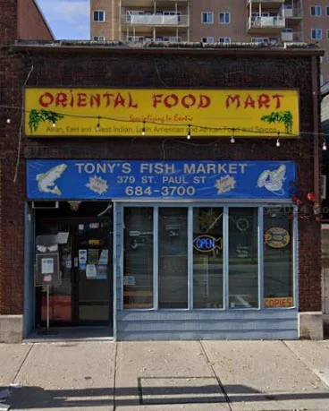 The blue and yellow storefront of Tony's Fish Market and Oriental Food Mart on St. Paul Street